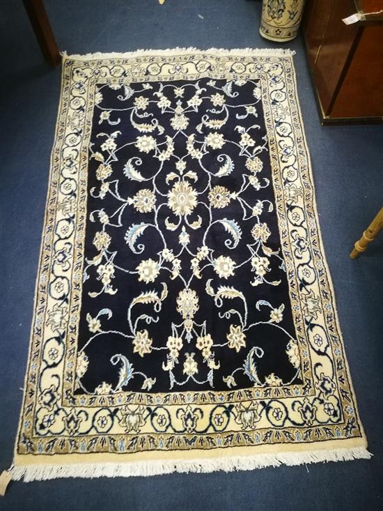 A Nain dark blue ground rug 190 x 115cm